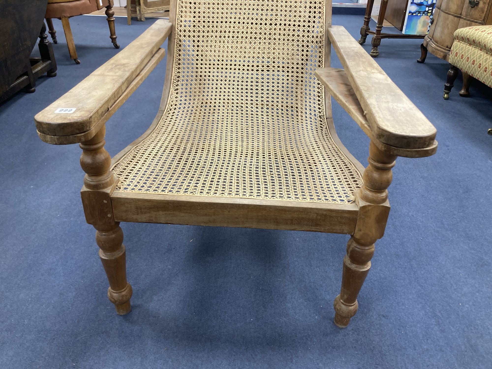 An early 20th century Anglo-Indian caned weathered plantation chair, width 66cm, depth 104cm, height 91cm
